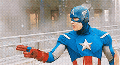 A Man In A Captain America Costume Is Pointing To Something GIF
