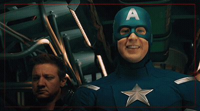 A Man In A Captain America Costume With An A On His Cape GIF