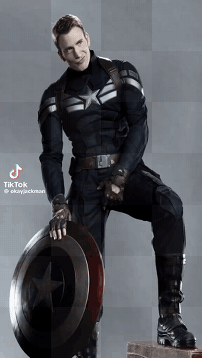 A Man In A Captain America Uniform Holds A Shield GIF