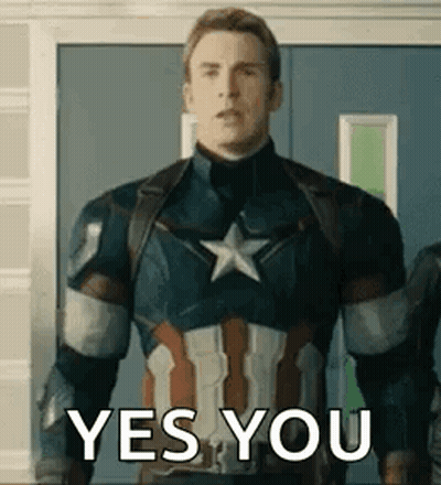 A Man In A Captain America Uniform Is Standing In Front Of A Door And Saying Yes You . GIF