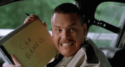 A Man In A Car Is Holding A Notepad That Says Car Ramrod On It GIF