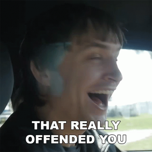 A Man In A Car Is Laughing With The Words That Really Offended You Above Him GIF