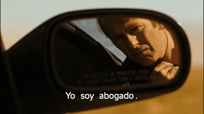 A Man In A Car Is Reflected In A Rear View Mirror With The Words Yo Soy Abogado GIF