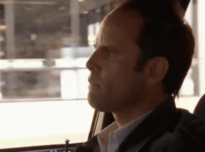 A Man In A Car Looking Out The Window GIF