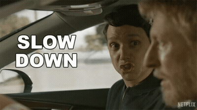 A Man In A Car Says Slow Down In White GIF