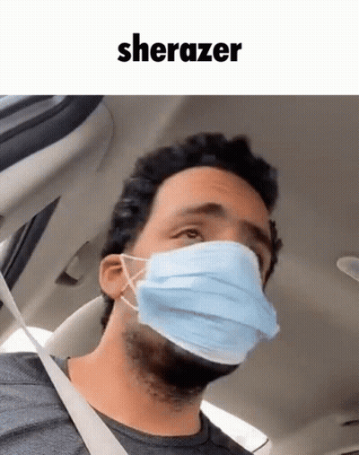 A Man In A Car Wearing A Face Mask With The Word Sherazer Above Him GIF