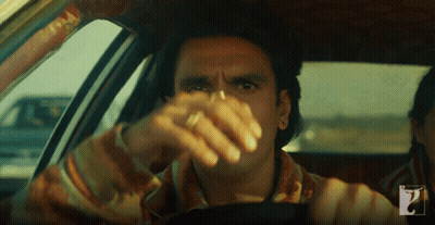 A Man In A Car With A Ring On His Finger Looks At The Camera GIF