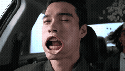 A Man In A Car With His Eyes Closed And His Mouth Open GIF