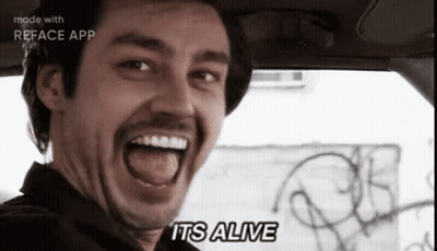 A Man In A Car With His Mouth Open And The Words " It 'S Alive " On The Bottom GIF