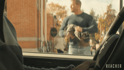 A Man In A Car With The Word Reacher On The Steering Wheel GIF