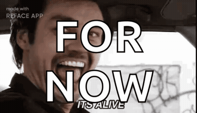 A Man In A Car With The Words For Now It 'S Alive On His Face GIF