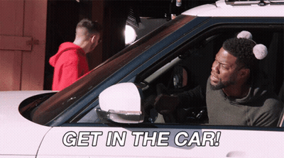 A Man In A Car With The Words Get In The Car Written On It GIF