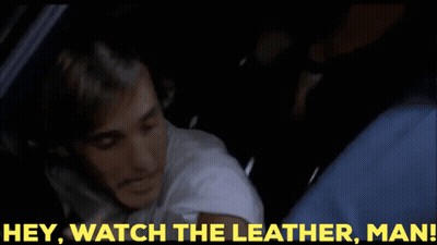 A Man In A Car With The Words Hey Watch The Leather Man Behind Him GIF