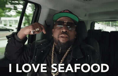 A Man In A Car With The Words I Love Seafood On The Screen GIF