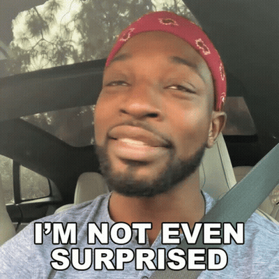 A Man In A Car With The Words I 'M Not Even Surprised On The Bottom GIF
