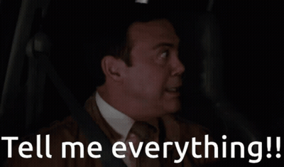 A Man In A Car With The Words Tell Me Everything Written Below Him GIF
