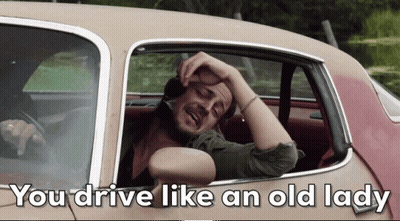 A Man In A Car With The Words You Drive Like An Old Lady GIF