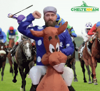 A Man In A Cartoon Horse Costume Rides A Horse In A Race GIF