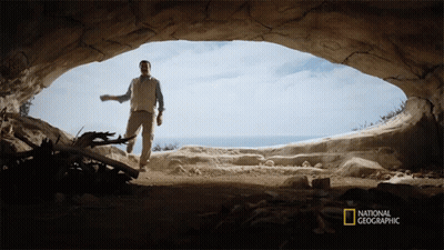 A Man In A Cave With A National Geographic Logo On The Bottom Right GIF