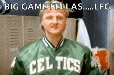 A Man In A Celtics Jacket Is Standing In A Locker Room . GIF