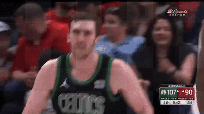 A Man In A Celtics Jersey Stands In Front Of A Crowd During A Basketball Game GIF