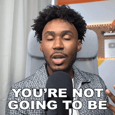 A Man In A Chair Says " You 'Re Not Going To Be " In Front Of A Microphone GIF