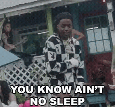 A Man In A Checkered Shirt Is Standing In Front Of A House And Says You Know Ain 'T No Sleep GIF