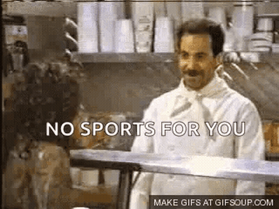 A Man In A Chef 'S Coat Is Standing In A Kitchen Talking To A Woman . GIF