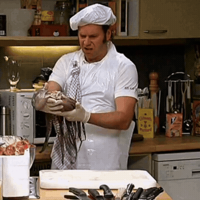 A Man In A Chef 'S Hat Is Holding A Large Octopus In His Hands GIF