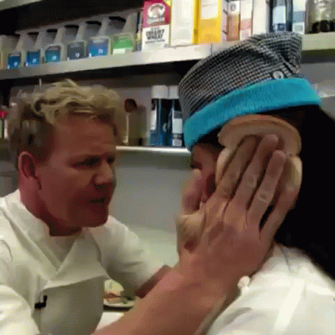 A Man In A Chef 'S Hat Is Putting A Slice Of Bread On A Woman 'S Face . GIF