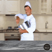 A Man In A Chef 'S Uniform Is Pouring Something Into A Pot In A Kitchen GIF