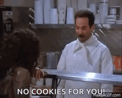 A Man In A Chef 'S Uniform Is Standing In A Kitchen Talking To A Woman . GIF