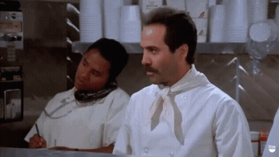 A Man In A Chef 'S Uniform Is Talking On A Cell Phone GIF