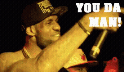 A Man In A Chicago Bulls Hat Is Holding A Microphone And Says You Da Man GIF