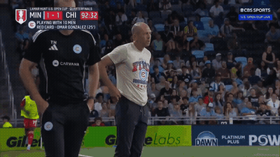 A Man In A Chicago Cubs Shirt Stands On The Field GIF