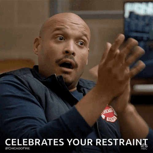 A Man In A Chicago Fire Dept Vest Is Clapping His Hands GIF
