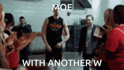 A Man In A Chicago Jersey Is Dancing In Front Of A Group Of People . GIF