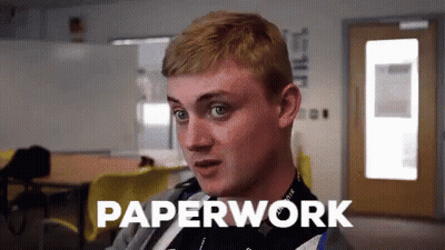 A Man In A Classroom With The Word Paperwork Written Above Him GIF