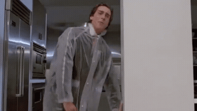 A Man In A Clear Coat Is Standing In A Kitchen . GIF