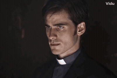 A Man In A Clergy Collar Looks Like A Vampire With Vidu In The Corner GIF