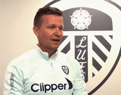 A Man In A Clipper Shirt Stands In Front Of A Shield GIF