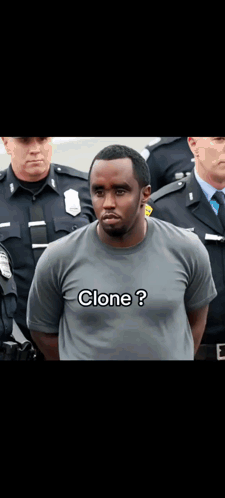 A Man In A Clone T-Shirt Is Standing In Front Of A Group Of Police Officers GIF