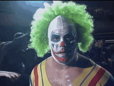A Man In A Clown Costume Has A Green Wig On GIF