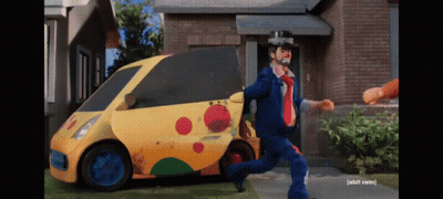 A Man In A Clown Costume Is Running Away From A Yellow Car That Says Taxi GIF