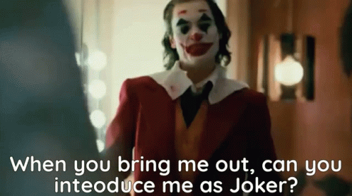 A Man In A Clown Costume Is Standing In A Room And Talking To Another Man . GIF