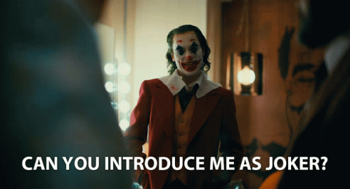 A Man In A Clown Costume Is Standing In A Room With The Words " Can You Introduce Me As Joker " Below Him GIF