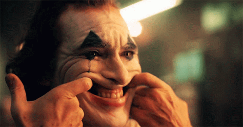 A Man In A Clown Mask Is Making A Funny Face GIF