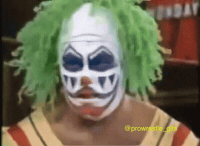 A Man In A Clown Mask With Green Hair GIF