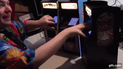 A Man In A Colorful Shirt Is Playing A Video Game GIF