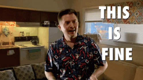 A Man In A Colorful Shirt Is Standing In A Living Room With The Words " This Is Fine " Behind Him GIF